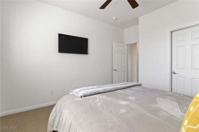Carpeted bedroom featuring ceiling fan and baseboards | Image 32