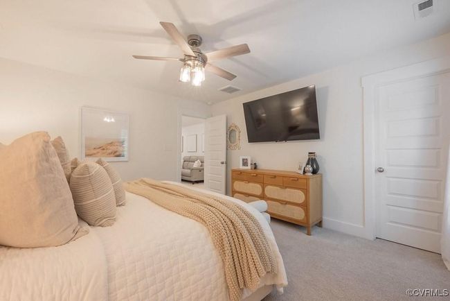 Bedroom featuring light carpet and a ceiling fan | Image 39