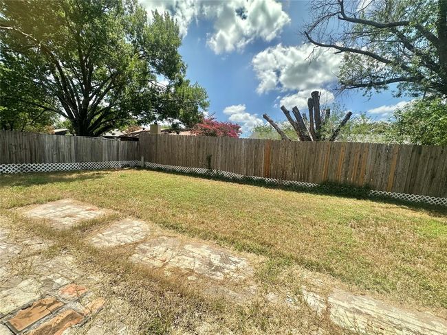 View of fenced backyard | Image 19