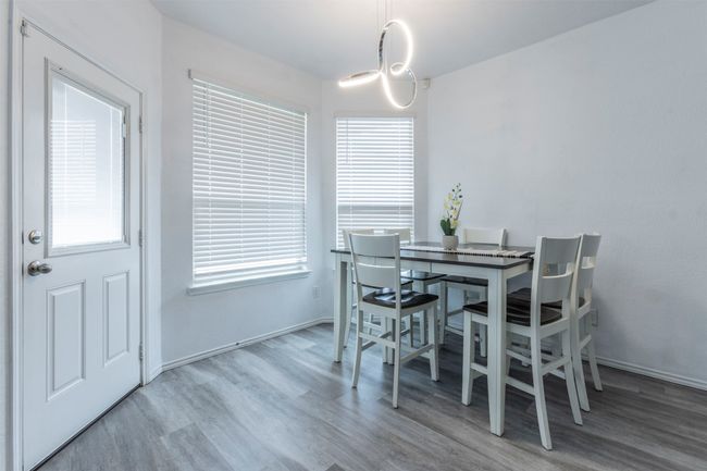 Dining area with plenty of natural light and wood finished floors | Image 9