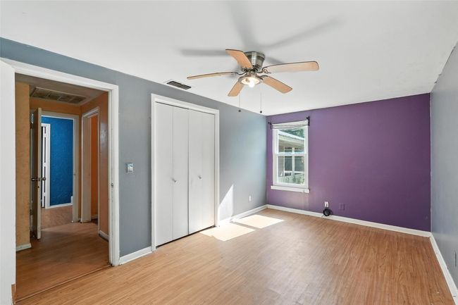 Unfurnished bedroom with light wood-style flooring, a closet, and a ceiling fan | Image 19