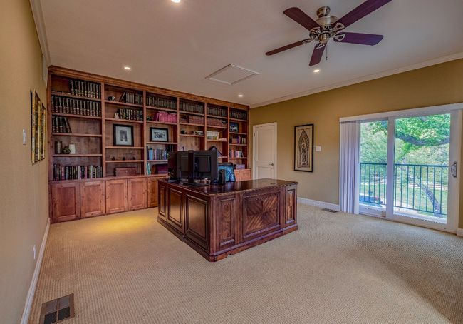Expansive upstairs office with porch, wall-to-wall custom shelving and large closet | Image 27