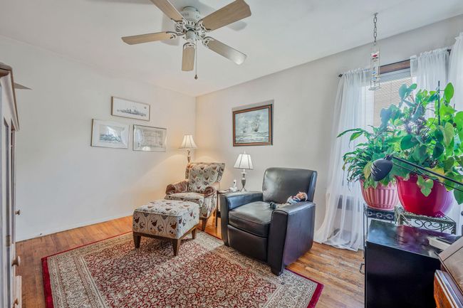 Sitting room featuring ceiling fan and wood finished floors | Image 14