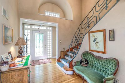 Entryway with a high ceiling and hardwood / wood-style flooring | Image 1