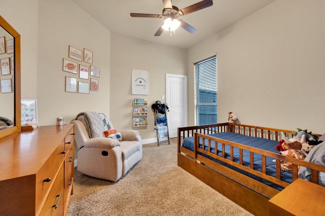 Bedroom with light carpet, baseboards, and a ceiling fan | Image 25