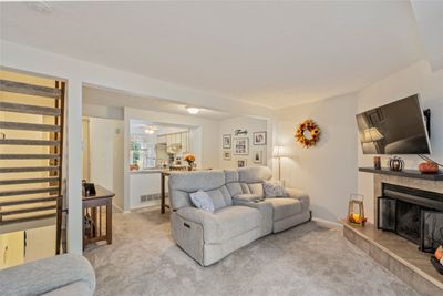 Enjoy the cozy feeling of this updated home with new plush neutral wall to wall carpeting, corner gas fireplace, open floor plan and so much more! Turnkey ready. Just unpack! | Image 3