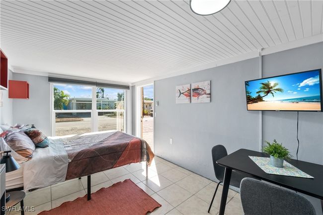 Bedroom with light tile patterned flooring | Image 17