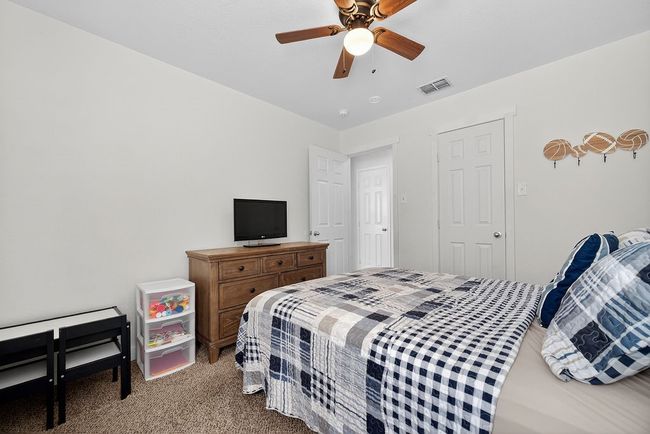 Carpeted bedroom featuring ceiling fan | Image 23