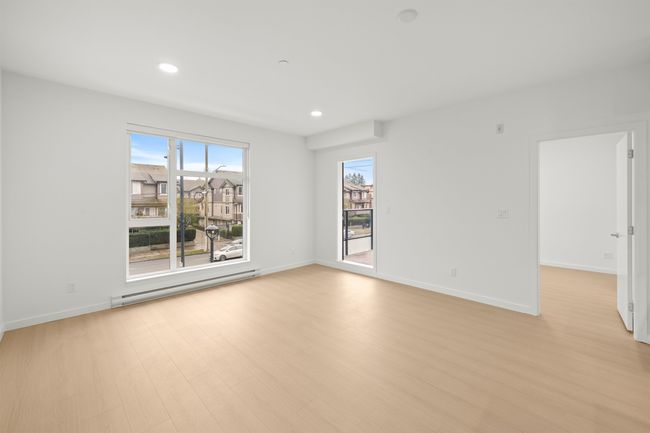 Spare room featuring baseboard heating, light wood-type flooring, and recessed lighting | Image 10