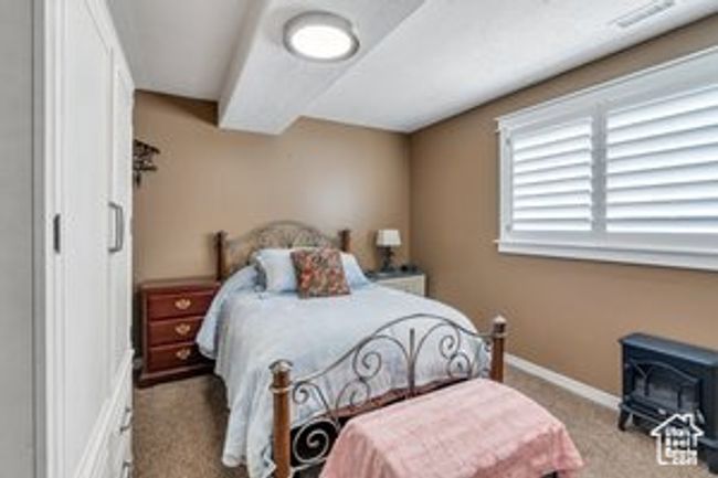 Bedroom with carpet and a wood stove | Image 14