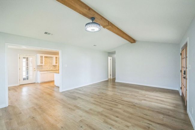 Living room opens to the kitchen and dining areas | Image 8