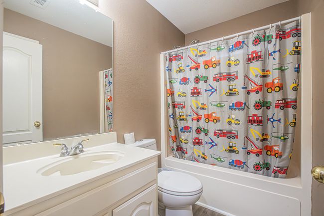 Full bathroom featuring vanity, shower / tub combo, and wood finished floors | Image 30