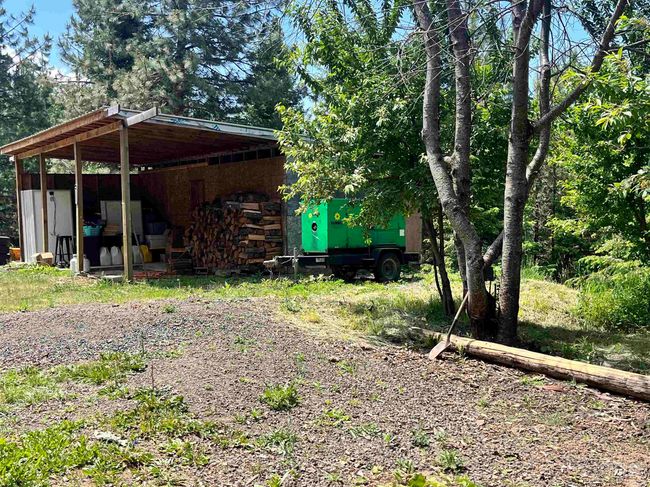 View of yard with an outbuilding | Image 48