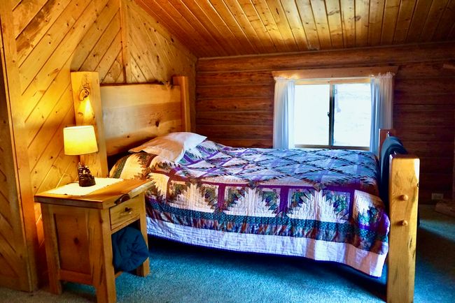 Bedroom featuring log walls, carpet, and wood ceiling | Image 38