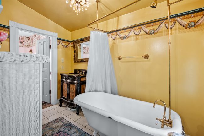 Bathroom with lofted ceiling, tile patterned floors, and a soaking tub | Image 17