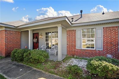 Doorway to property featuring a porch | Image 3