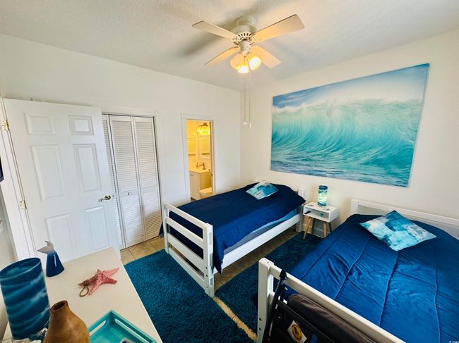 Tiled bedroom with a closet and ceiling fan | Image 13