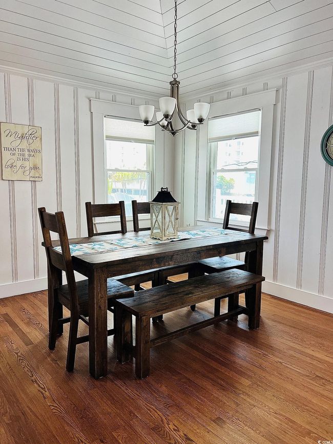 Dining area with a notable chandelier, wood ceiling, and wood-type flooring | Image 7