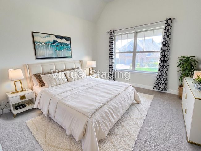 Bedroom featuring light colored carpet and vaulted ceiling | Image 30