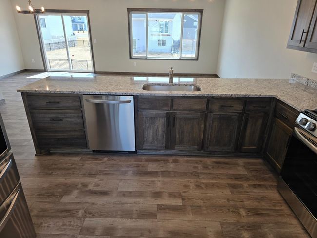 Nice bank of drawers next to the dishwasher. There is a built in garbage/recycling center in the base cabinet. | Image 5