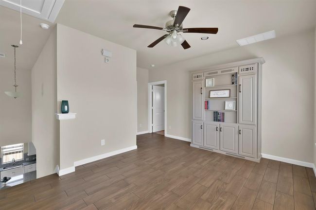 The tile floors continues up the stairs and into the common areas upstairs. The game room also includes a hidden Murphy bed in the book shelf! | Image 19