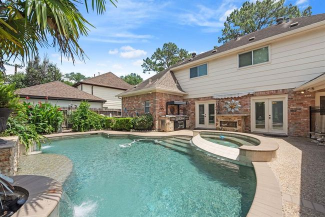 Step outside into this oasis! Outdoor kitchen and serving area for your poolside enjoyment! | Image 35