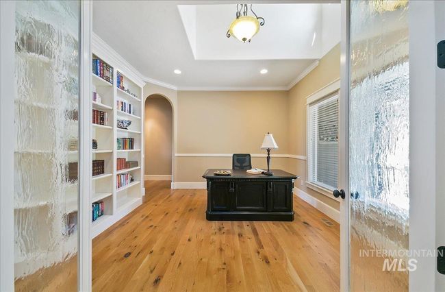 Office area with arched walkways, ornamental molding, light wood finished floors, recessed lighting, and built in features | Image 4
