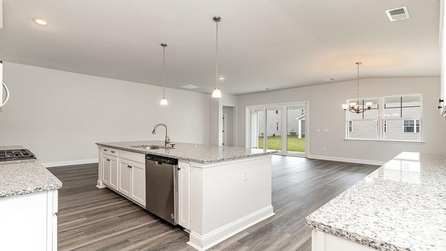 Kitchen featuring stainless steel dishwasher, sink, dark wood-type flooring, and an island with sink | Image 14