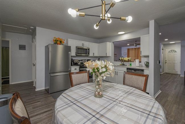 Newly renovated kitchen with stainless steel appliances and modern light fixtures | Image 4