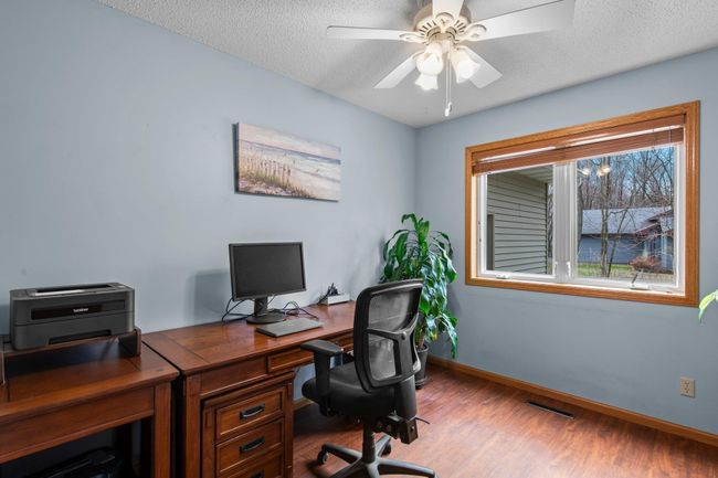 Main floor bedroom with walk-in closet is currently used as an office | Image 16