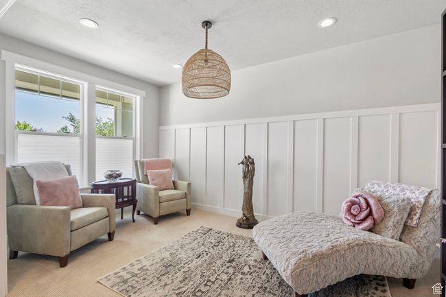 Sitting room featuring a decorative wall, wainscoting, light carpet, recessed lighting, and a textured ceiling | Image 14