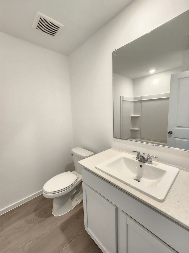 Bathroom with wood finished floors and vanity | Image 7