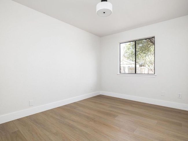 Unfurnished room featuring baseboards and light wood-style floors | Image 21