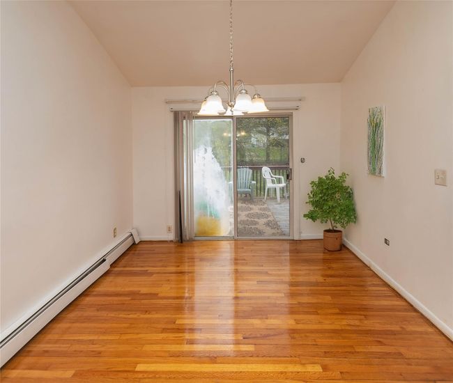Dining area featuring gleaming hardwood floors and sliders to deck | Image 4