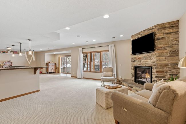 The lower level of this home is a true entertainer's paradise, featuring a full bar, large family room with gas fireplace, a movie room, and an expensive wine cellar. | Image 49