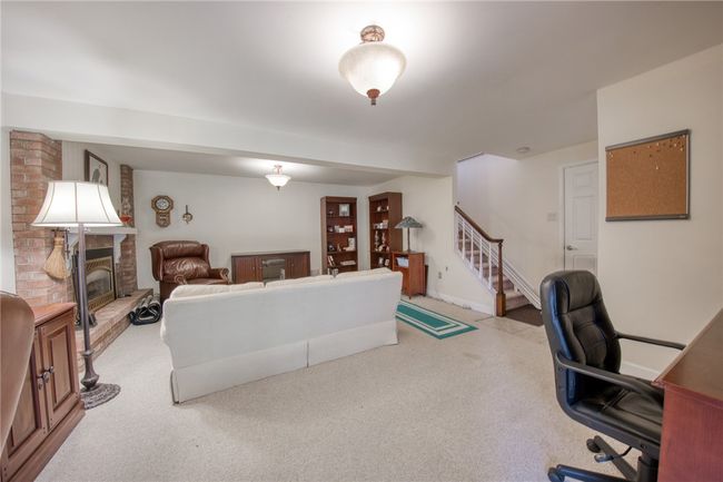 Game room with newer carpet and access to the backyard | Image 35