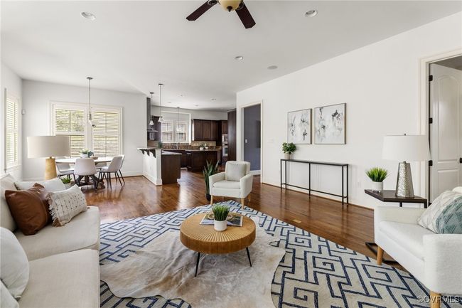 10'Ceilings, 8' door, Gas fireplace, Site finished hardwood floors, Ceiling fan with light fixture, Recessed lighting, Floor outlet, Access to rear patio, Surround sound | Image 17