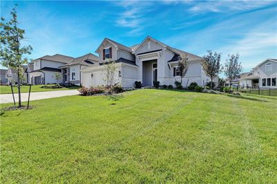 View of front of property featuring a garage and a front yard | Image 1