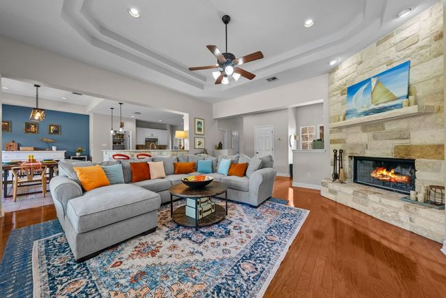 Traditional stone fireplace with raised hearth & mantel grace the family room | Image 5
