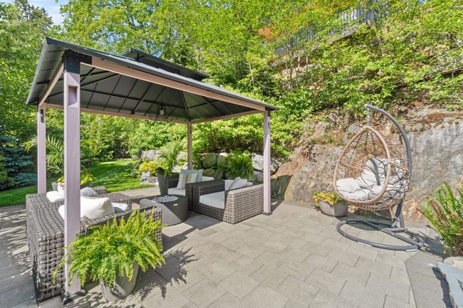 View of patio with a gazebo and an outdoor hangout area | Image 21