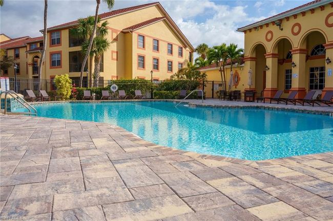 Community pool with fence and a patio | Image 31