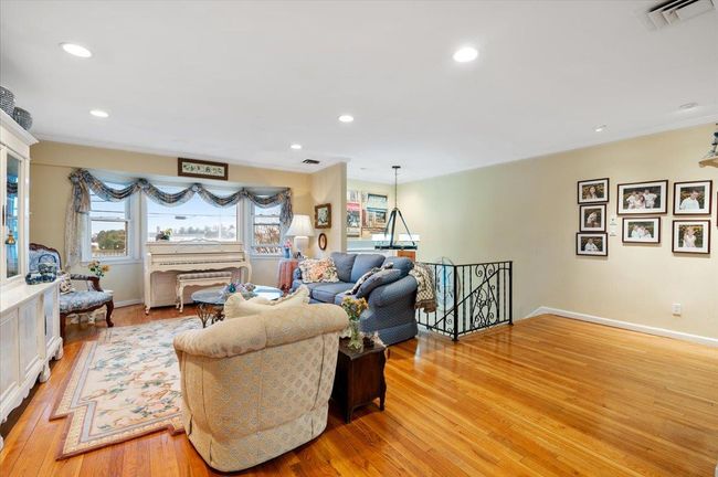 Living area featuring recessed lighting, baseboards, light wood-type flooring, and visible vents | Image 4