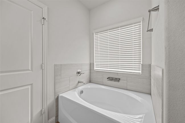 Full bathroom with a bath | Image 22