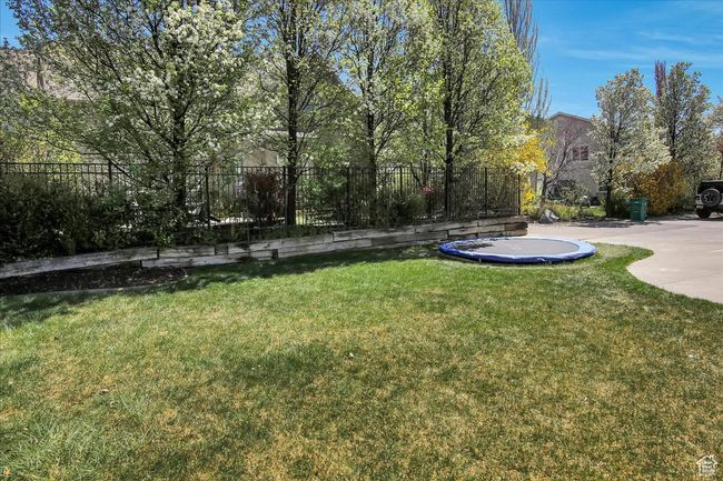 View of yard featuring fence and a trampoline | Image 27