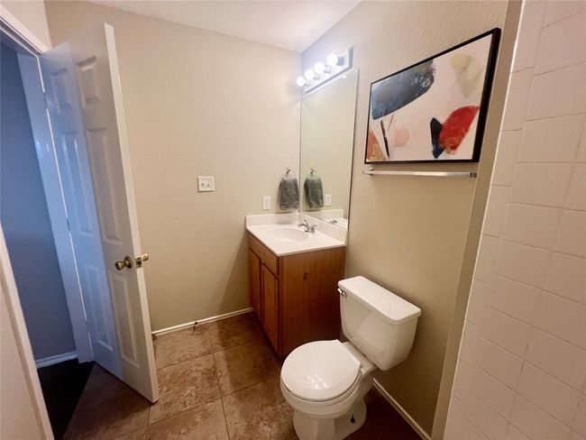 Bathroom featuring vanity and toilet | Image 11