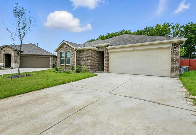 Ranch-style house with brick siding, a garage, driveway, and a front lawn | Image 21