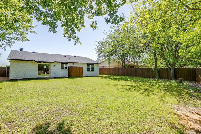 View of fenced backyard | Image 28