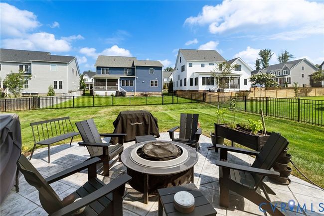 Fenced backyard featuring a fire pit, a residential view, and a patio | Image 42