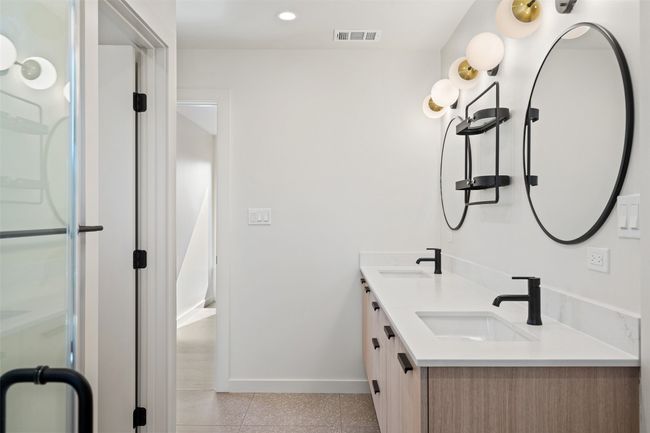Bathroom featuring double vanity, a sink, visible vents, and baseboards | Image 19