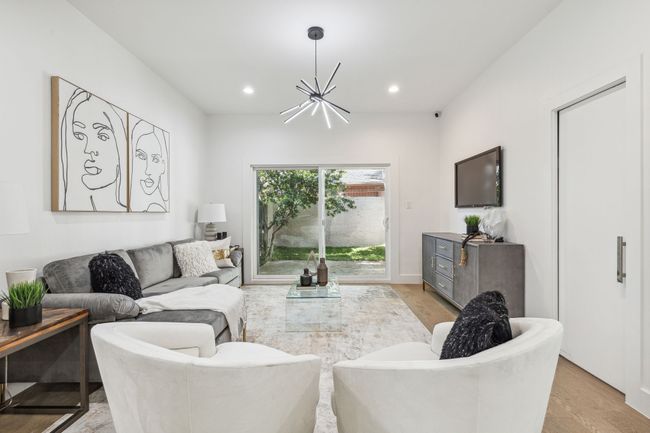 Living area with recessed lighting and a chandelier | Image 17